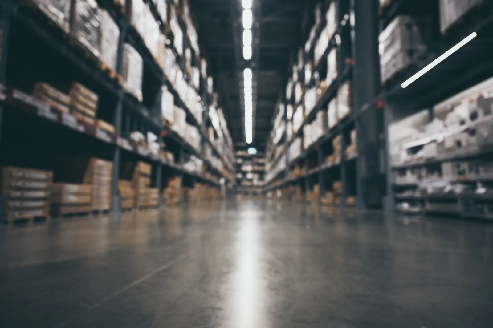 Warehouse aisle with stacked pallets and shelving